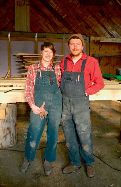 Sarah McCarty and Ben Blohoweak in their barn at Cold Climate Farms