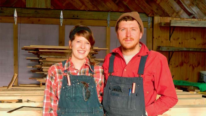 Sarah McCarty and Ben Blohoweak in their barn at Cold Climate Farms